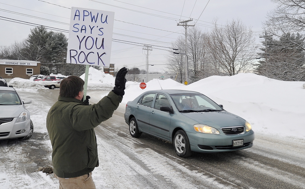 Tim Doughty, a member of the American Postal Workers Union, thanks returning FairPoint workers. Gordon Chibroski/Staff Photographer