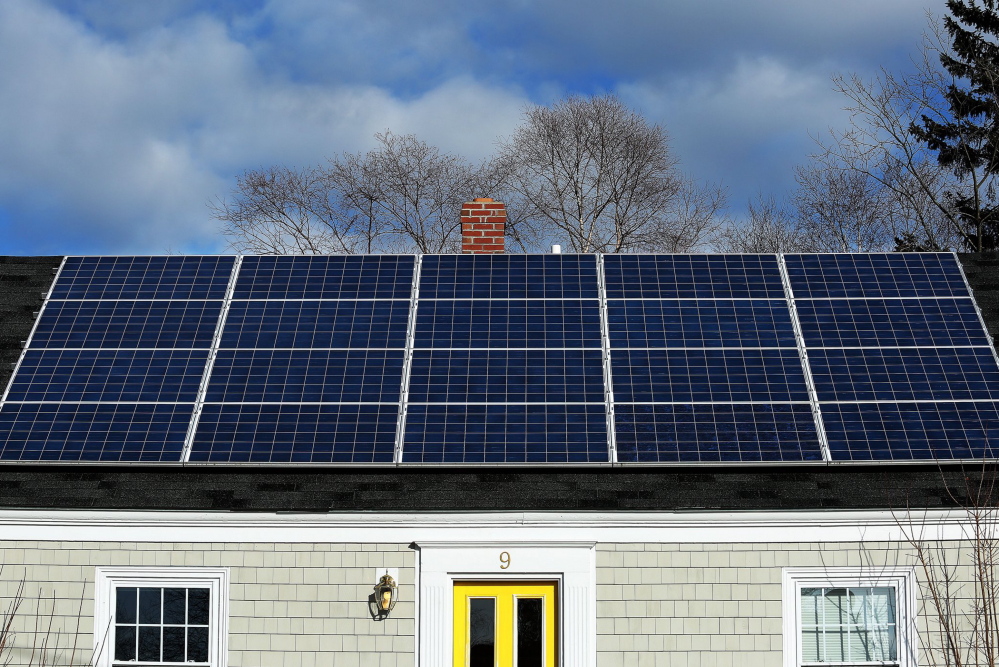 A solar panel array gathers sunlight on the roof of a house on Lynda Road in Portland in 2015.