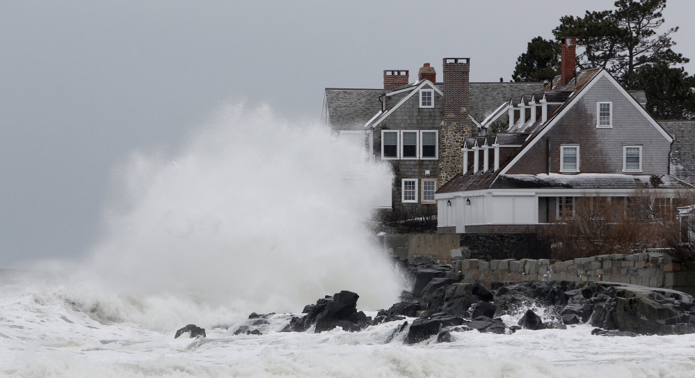 Storm-driven waves slam into the rocks in front of a house along the shore in Kennebunk on March 8, 2013.