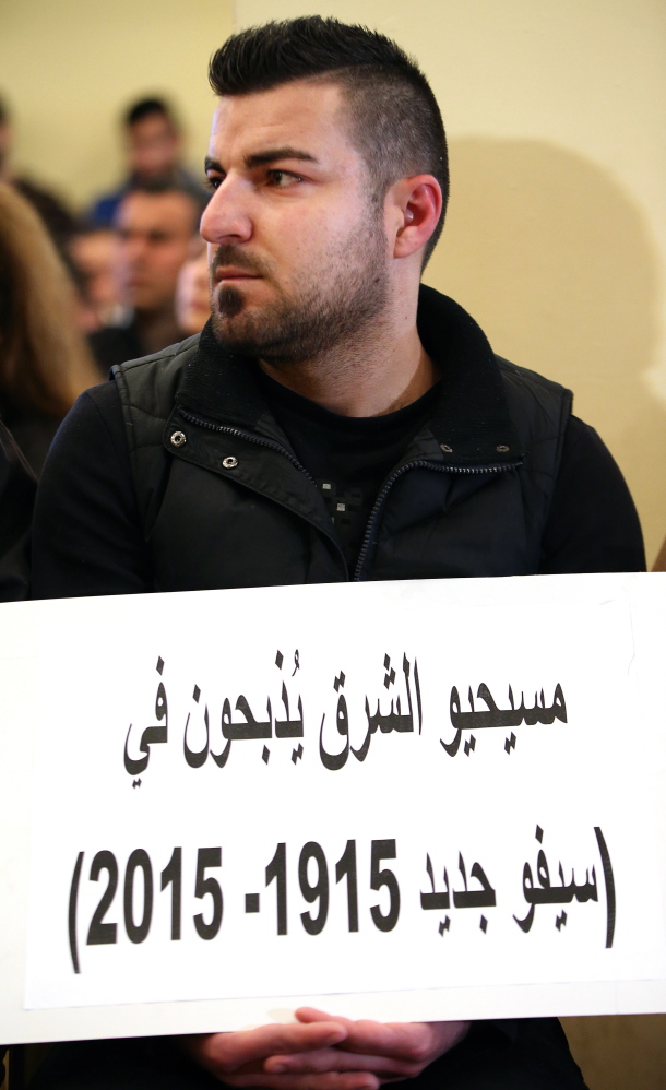 A man whose relatives were abducted in Syria participates in a sit-in in Beirut. His placard reads, “The Christians of the east are being slaughtered in a new massacre.”