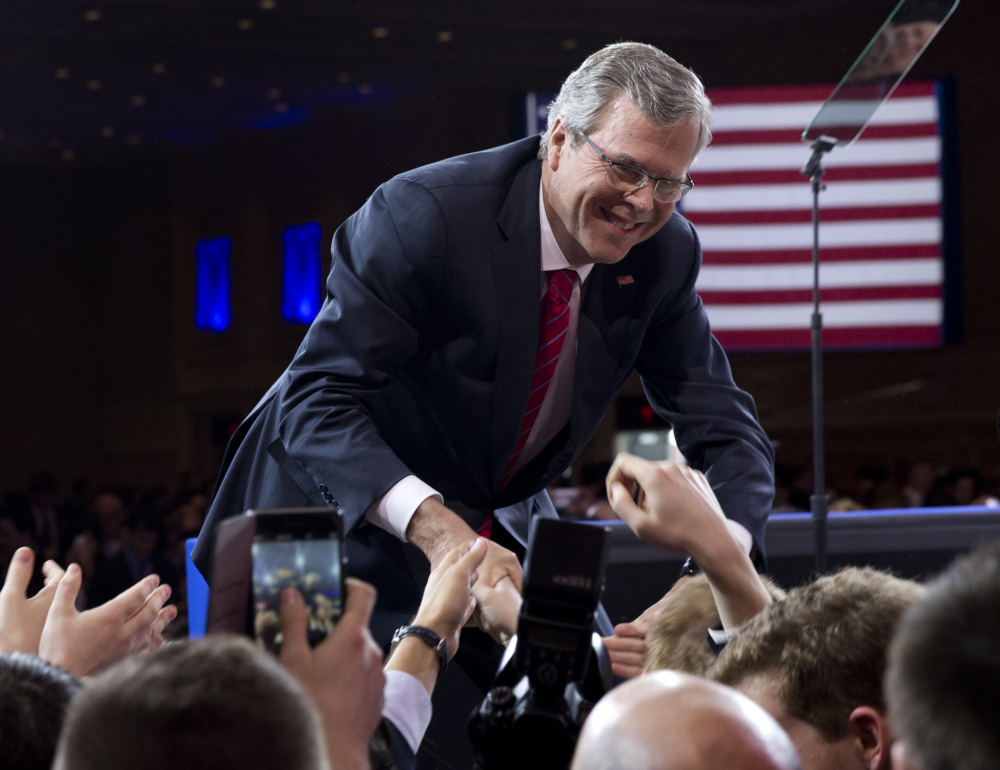 Former Florida Gov. Jeb Bush shakes hands with people in the audience after speaking at the Conservative Political Action Conference in National Harbor, Md., on Friday.