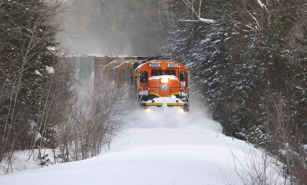Train 202 of the Central Maine & Quebec Railway forges through snow-covered tracks in Orneville Township – a typical scene for a very unusual winter in New England.