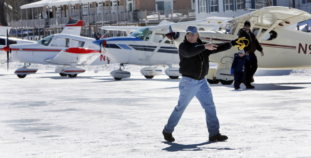 Ice runway manager Paul LaRochelle, parks planes in Alton Bay on frozen Lake Winnipesaukee on Saturday Alton, N.H.  LaRochelle and his crew work to plow and keep the only ice runway in the lower 48 states approved by the Federal Aviation Administration open to pilots.