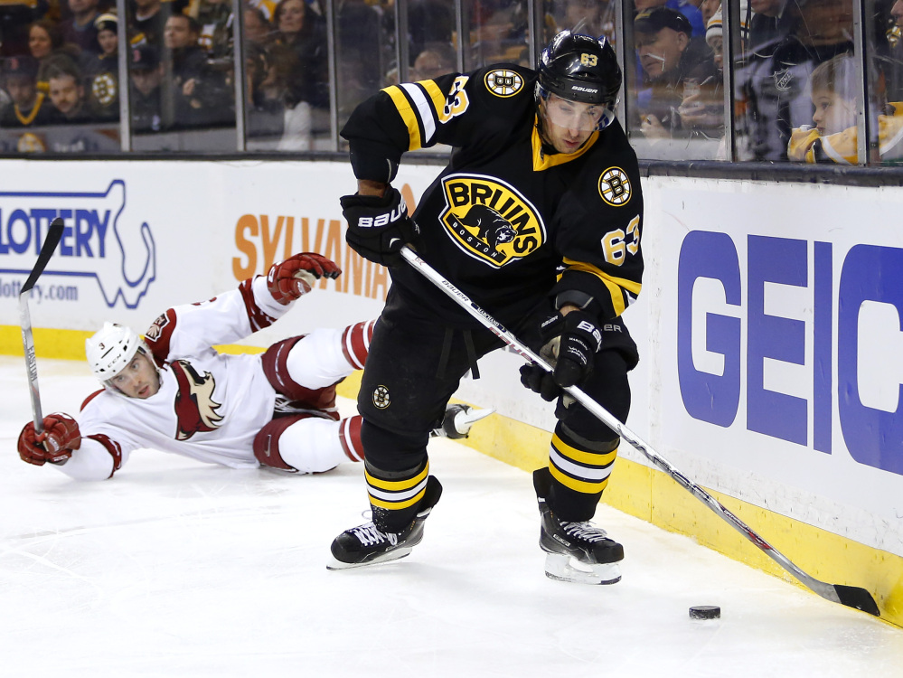 Boston’s Brad Marchand skates away from Arizona’s Keith Yandle during the second period of the Bruins’ 4-1 win Saturday in Boston. Marchand had a goal and the Bruins have won three of four after losing six straight.
