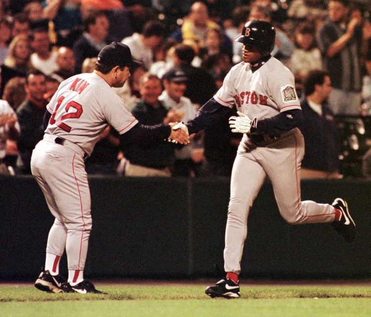 Red Sox third base coach Wendell Kim congratulates Damon Buford after he hit a grand slam in a 1999 game against the Baltimore Orioles. The Associated Press/File photo