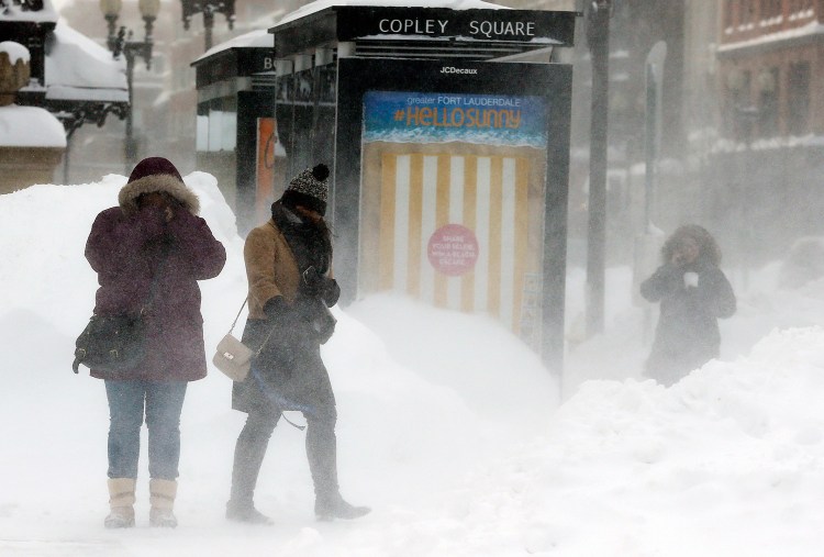 Pedestrians brace against blowing snow in Copley Square in Boston Sunday. A storm brought a new round of wind-whipped snow to New England on Sunday, threatening white-out conditions in coastal areas and forcing people to contend with a fourth winter onslaught in less than a month. 