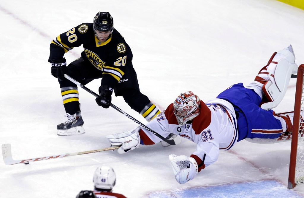 Bruins left wing Daniel Paille, left, and Montreal goalie Carey Price vie for control of the puck during the first period of the Canadiens’ 3-1 win Sunday in Boston. The Associated Press