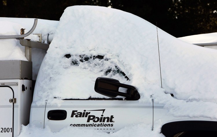 A FairPoint truck is covered in snow at one of the company’s offices in February 2015 in Concord, N.H.