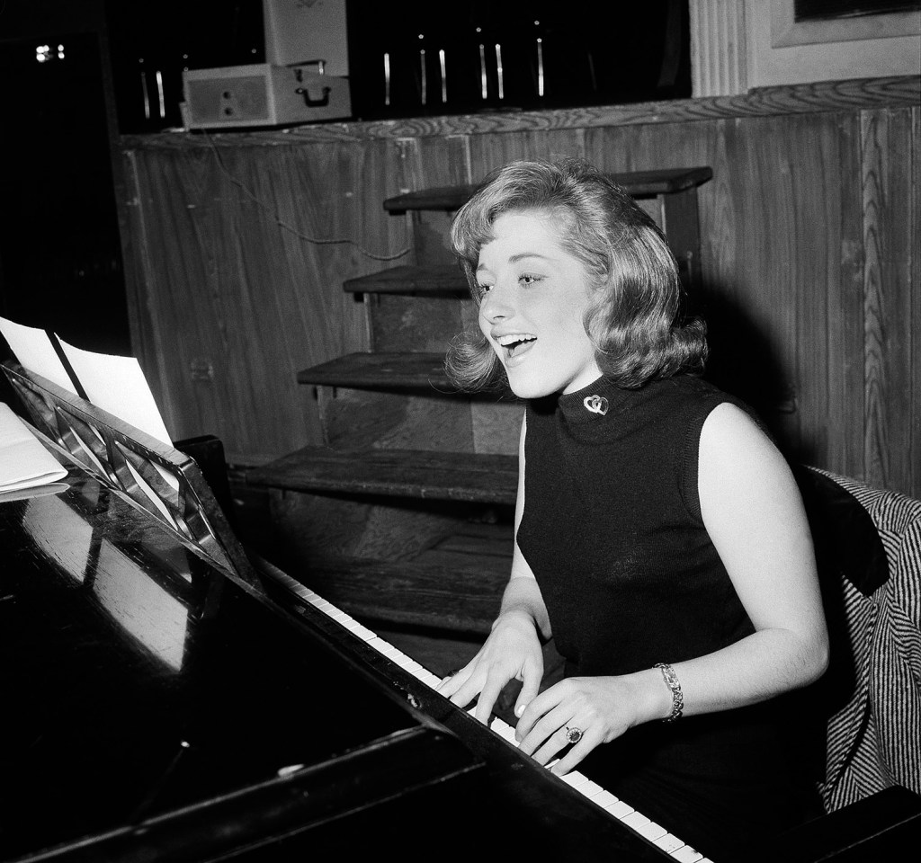 In this 1966 file photo, Lesley Gore rehearses at a piano in New York.  She died of cancer Monday. The Associated Press
