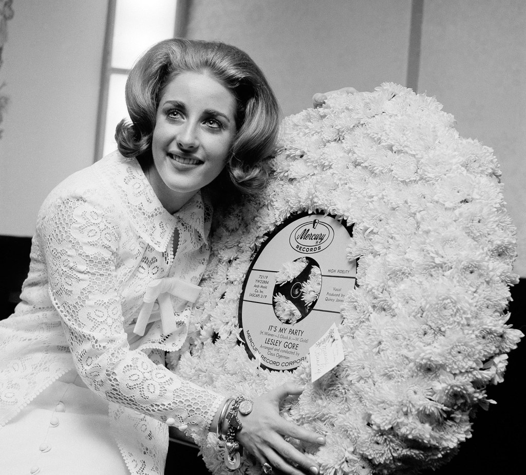 In this 1964 file photo, singer Lesley Gore hugs a flowered record at her 18th birthday party celebrated at the Delmonico Hotel in New York. Gore died of cancer, Monday. She was 68. The Associated Press