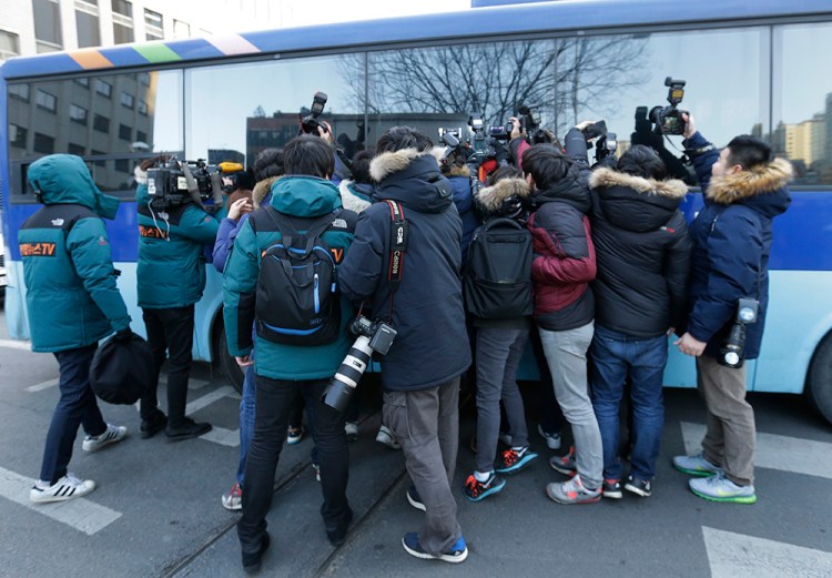 Members of the media try to get pictures of Cho Hyun-ah, the former vice president of Korean Air Lines, outside of the Seoul Western District Court after her trial in Seoul Thursday. The Associated Press