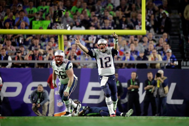 New England Patriots quarterback Tom Brady (12) celebrates a 4-yard touchdown against the Seattle Seahawks during the second half of NFL Super Bowl XLIX football game Sunday. The Associated Press