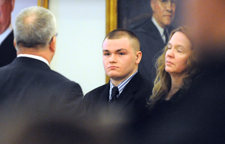 Kyle Dube, center, with his attorneys Stephen Smith, left, and Wendy Hatch appears in court on Feb. 23, the first day of his trial at the Penobscot Judicial Center in Bangor. The Associated Press