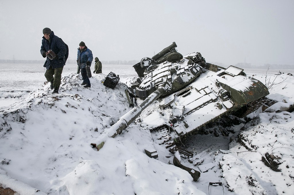 Members of the separatist self-proclaimed Donetsk People's Republic army collect parts of a destroyed Ukrainian army tank in the town of Vuhlehirsk, about 6 miles to the west of Debaltseve, on Monday. Reuters