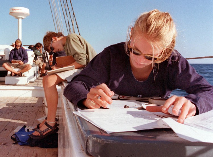 Tracey Mohr of Falmouth does homework aboard the Harvey Gamage as it sails out of Stonington, Connecticut. Students aboard the schooner studied history, science, literature and applied math classes in addition to learning navigation.