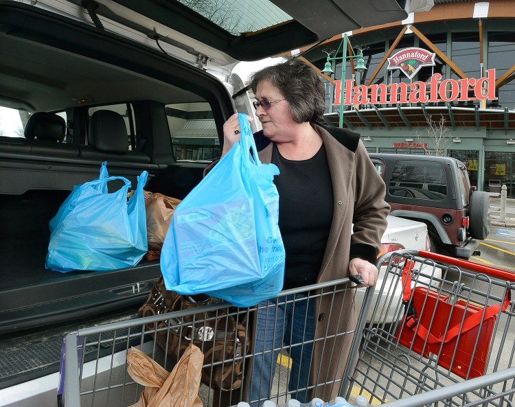Joan Cushman of Portland loads groceries into her car at Hannaford's Forest Avenue store, which will charge for plastic bags after a city ordinance takes effect April 15. Hannaford's Portland stores will give out reusable bags from March 29 through April 14.
John Patriquin/Staff Photographer