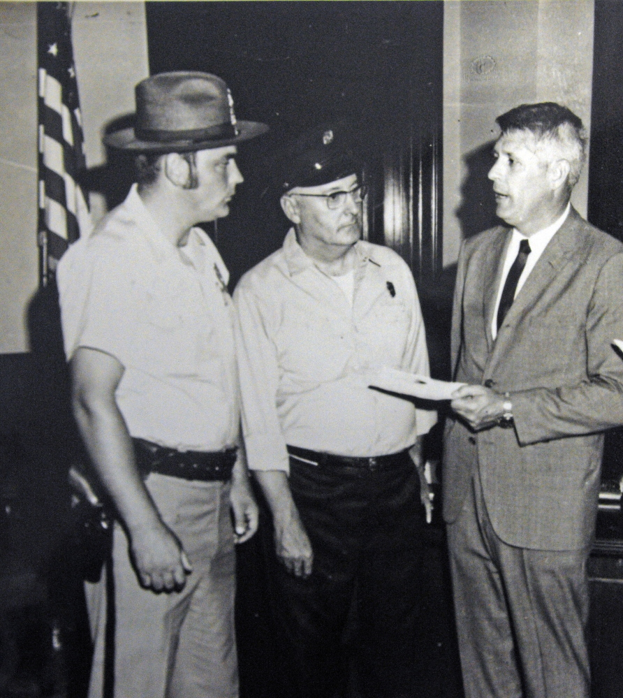 This undated handout photo shows, from left, Augusta police Officer Charles Winslow, Augusta firefighter Laurier Jacques and Gov. Ken Curtis.