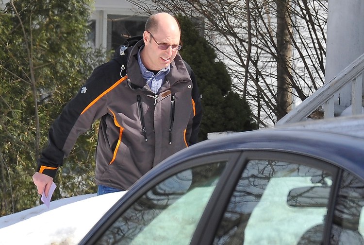 Owner Gregory Nisbet leaves his building on Dartmouth Street in Portland after inspectors leave Tuesday.