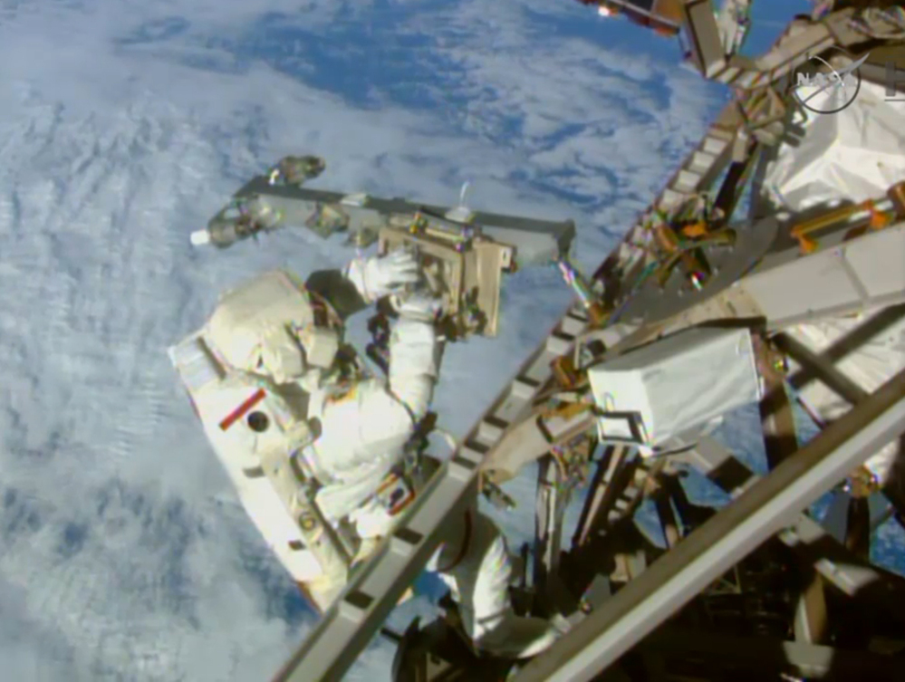 Astronaut Terry Virts installs an antenna and boom during the third spacewalk outside the International Space Station on Sunday. American astronauts Terry Virts and Butch Wilmore had 400 more feet of power and data cable, as well as two antennas, to install Sunday.