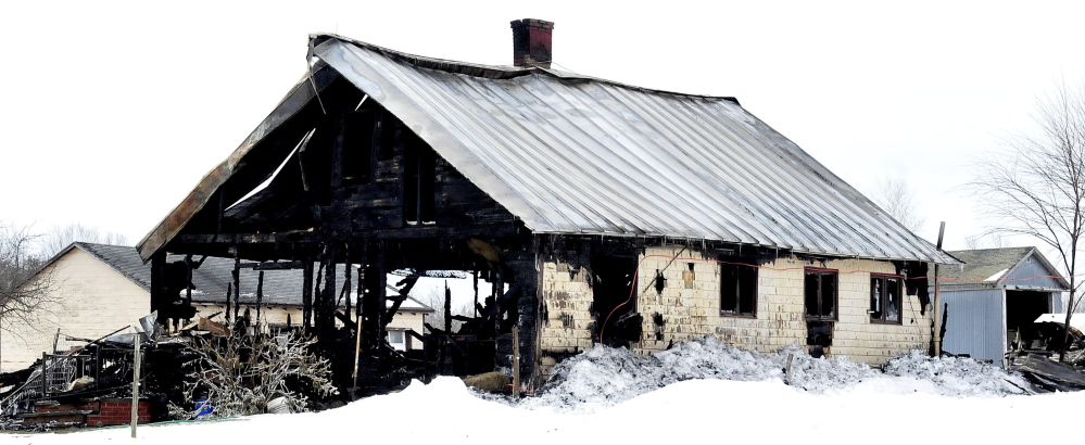Fire destroyed this old farmhouse on the Weeks Mills Road in New Sharon on Friday night, leaving a family of seven homeless.