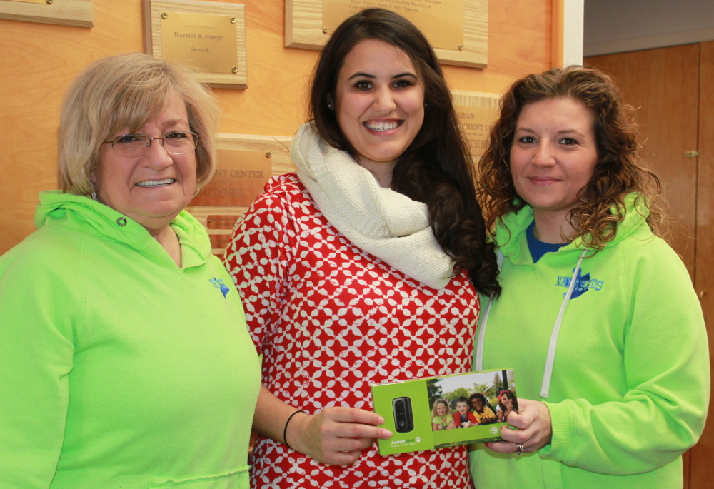 Donna “Nana” Green, left, and Jessica Lee, right, of Nana’s Kids of York present Sarah Mehlhorn of the Fraser-Ford Child Development Center in Sanford with an Amber Alert GPS unit to benefit a child with autism.