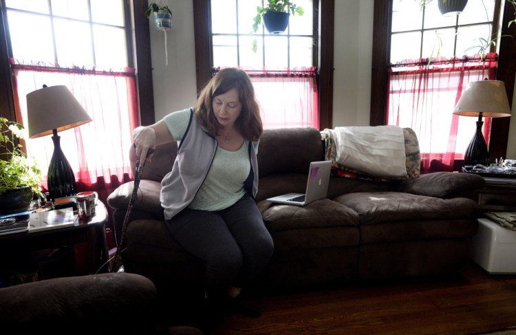 Lisa Lawlor of Saco, 43, had to find a doctor in New Hampshire after no physicians in Maine would treat her Lyme disease with long-term antibiotics. Before the treatment she could barely walk, but now she just uses a cane and lives close to a normal life.