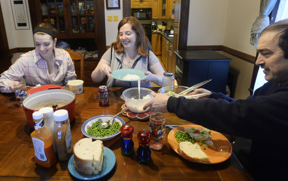Lisa Lawlor has a meal with her daughter, Madison, left, and husband, David. Madison says she’s happy about her mother’s recovery from Lyme disease: “She used to be very outgoing and outspoken, and she’s getting that back now. We’re happy the medications worked.”