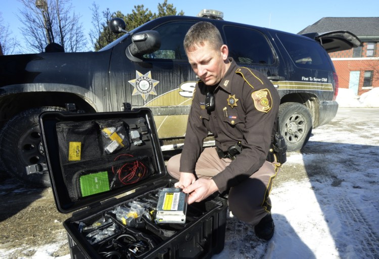 Andrew Hanna, a Cumberland County sheriff’s deputy, unpacks his crash assessment tool kit, which holds about $10,000 worth of high-tech  gear.