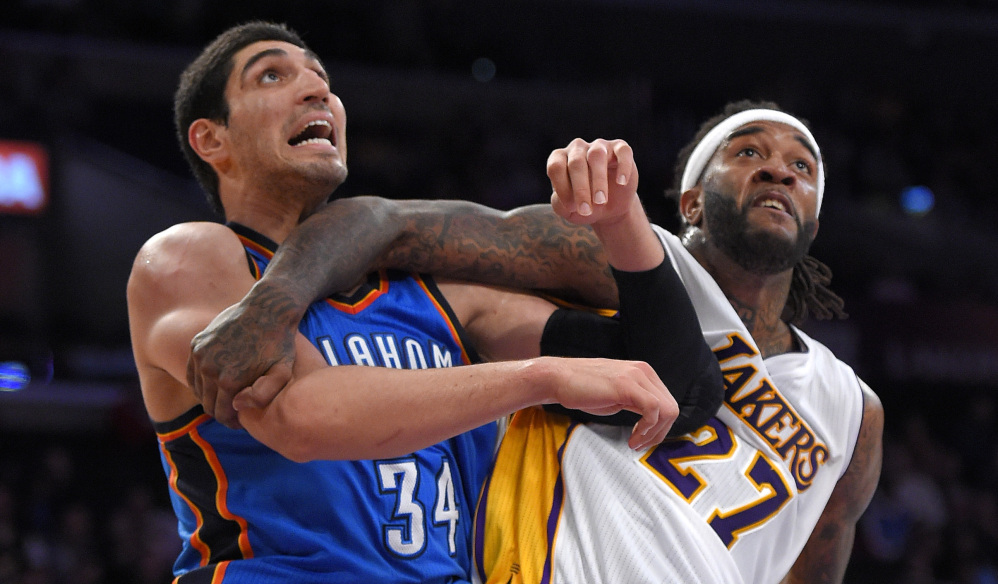 Oklahoma City center Enes Kanter, left, and Lakers center Jordan Hill battle for position during Sunday’s game in Los Angeles. The Thunder played without stars Kevin Durant and Russell Westbrook but won 108-101.
