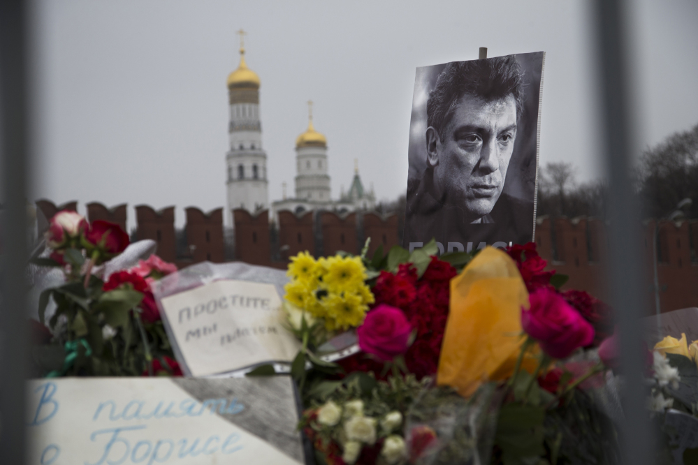 Flowers and a condolence message that reads “In memory of Boris” are placed with a portrait of Boris Nemtsov, a charismatic Russian opposition leader and sharp critic of President Vladimir Putin, at the site where Nemtsov was gunned down near the Kremlin, against a backdrop of the Kremlin Wall, in Moscow on Monday.