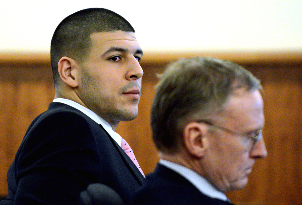Former New England Patriots player Aaron Hernandez, left, sits with his attorney Charles Rankin during his murder trial at Bristol County Superior Court on Friday in Fall River, Mass. Hernandez is charged with murder in the killing of Odin Lloyd in 2013.