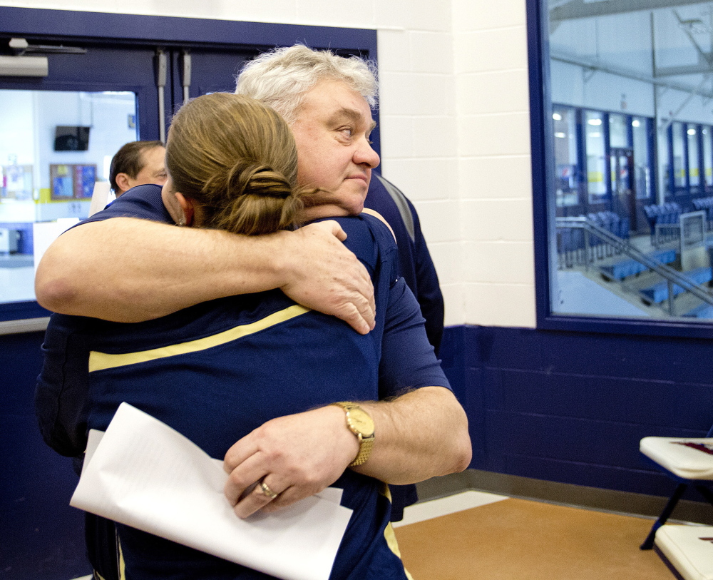 Gary Fifield hugs assistant coach Rachele Burns after announcing his retirement as USM women’s basketball coach Tuesday. ‘This was not an easy decision,” he said.