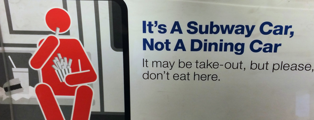 A placard reminds passengers to let the meal wait until the ride is over.