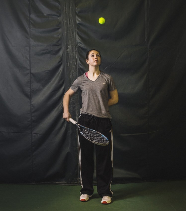 Rosemary Campanella practices Tuesday at Foreside Fitness & Tennis in Falmouth. A freshman player at Wells High School, where no varsity team exists, Campanella could play for Kennebunk, according to Maine Principals’ Association rules, but her matches would be forfeits, hindering the team’s score.