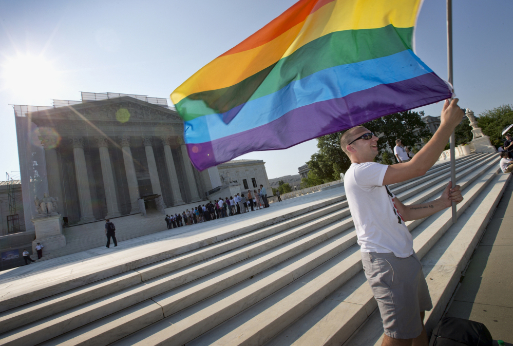 Vin Testa of Washington waves a rainbow flag in support of gay rights outside the Supreme Court in Washington in June 2013.  The Supreme Court will hear arguments over same-sex marriage on April 28. 