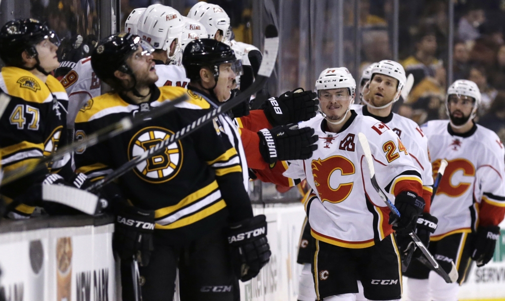 Calgary Flames left wing Jiri Hudler (24) is congratulated by teammates after his goal against the Bruins in the second period of Thursday night’s game in Boston. The Flames won, 4-3, in a shootout.