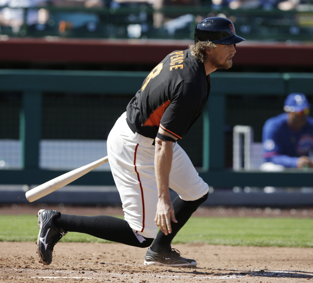 The Giants’ Hunter Pence grounds out during a spring training game against the Cubs on Thursday. Pence was hit by a pitch later in the game and sustained a broken forearm.