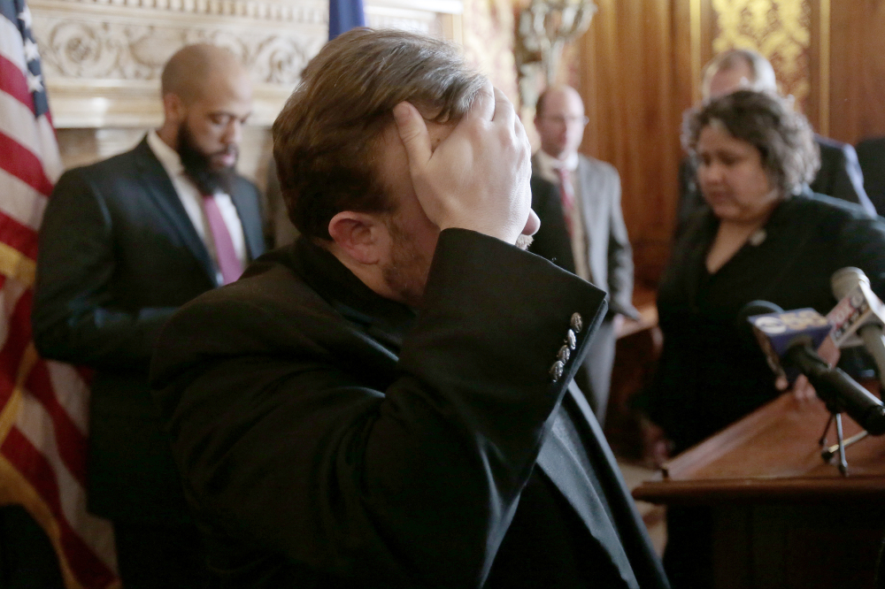 After more than 24 hours of debate, Wisconsin Rep. Cory Mason, D-Racine, wipes his face at the end of a news conference following passage of right-to-work legislation in the Assembly at the State Capitol in Madison, Wis., on Friday.