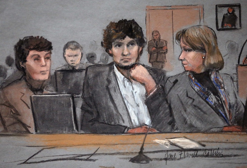 In this courtroom sketch, Dzhokhar Tsarnaev is depicted between defense attorneys Miriam Conrad, left, and Judy Clarke, right, during his federal death penalty trial Thursday in Boston. Tsarnaev is charged with conspiring with his brother to place two bombs near the Boston Marathon finish line in April 2013, killing three and injuring 260 people.