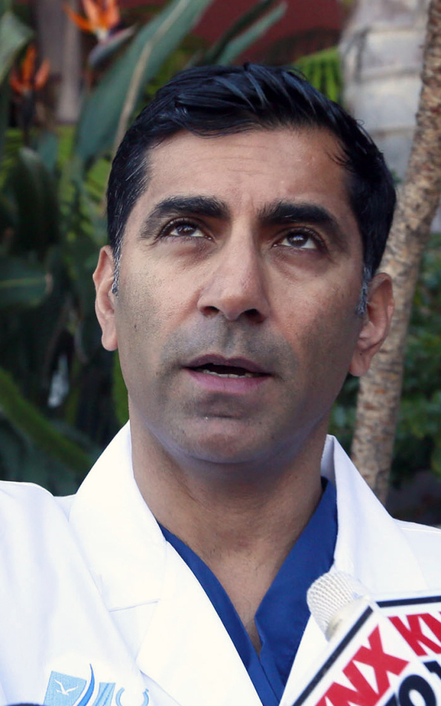 Dr. Sanjay Khurana talks to reporters at his office in Marina Del Rey, Calif., on Friday about seeing Ford’s plane falling from the sky while he was on a golf course Thursday. Khurana was among the first to go to Ford’s aid. The Associated Press