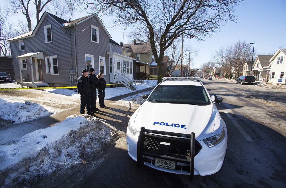 Madison Police stand outside the scene of a police involved shooting at a home in Madison, Wis., on Saturday.