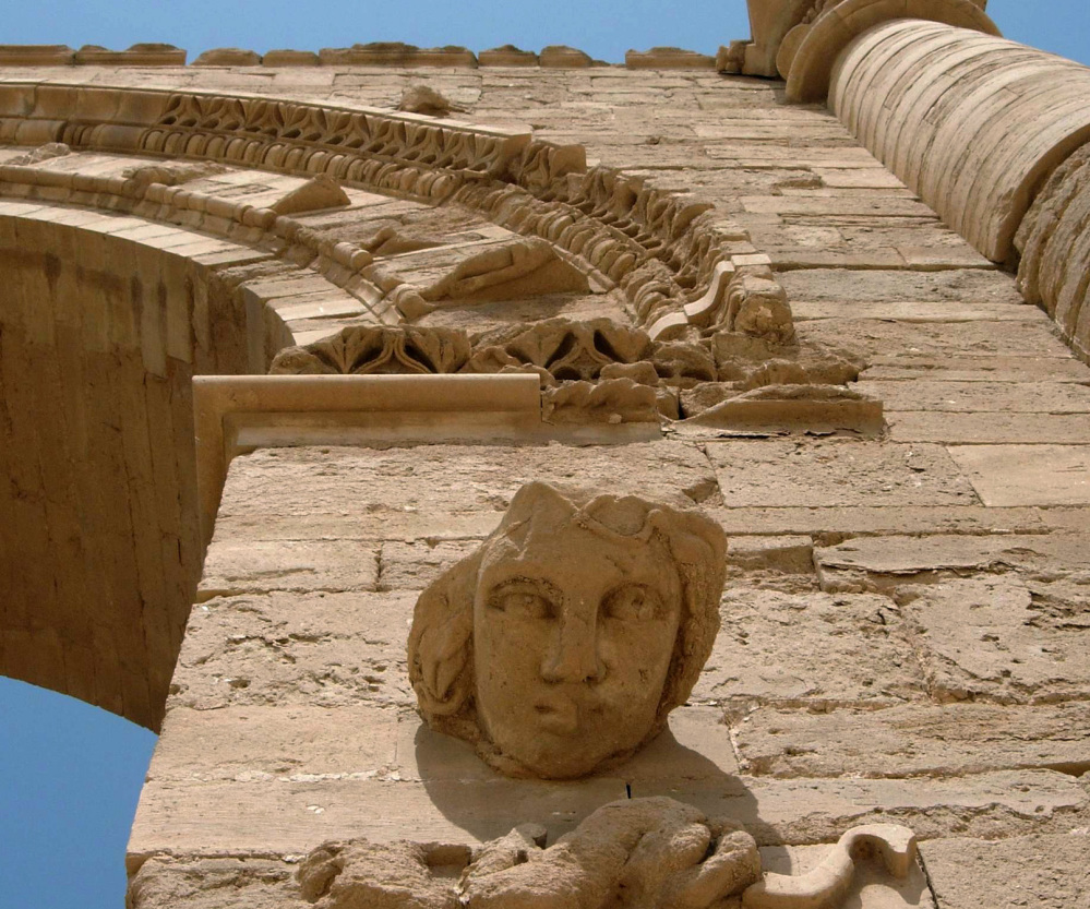 The face of a woman adorns ruins in Hatra, Iraq, which the Islamic State group looted and damaged a day after bulldozing the historic city of Nimrud.