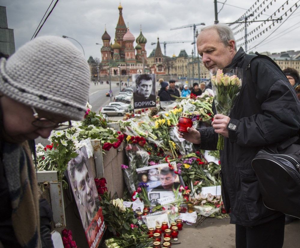 Mourners lay flowers and candles Saturday at the site in Moscow where Boris Nemtsov, a sharp critic of President Putin, was gunned down Feb. 27.