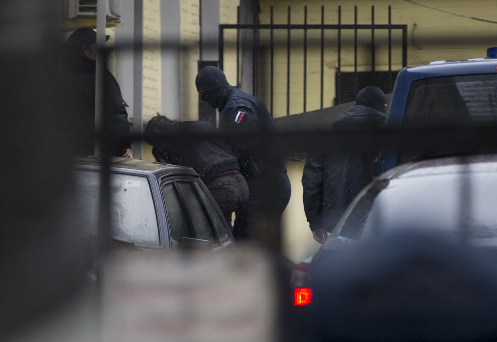 Police escort the suspects in the killing of Boris Nemtsov into a courthouse in Moscow on Sunday.