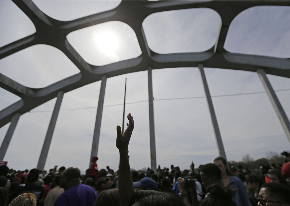 Crowds take a symbolic walk across the Edmund Pettus Bridge, Sunday, in Selma, Ala.