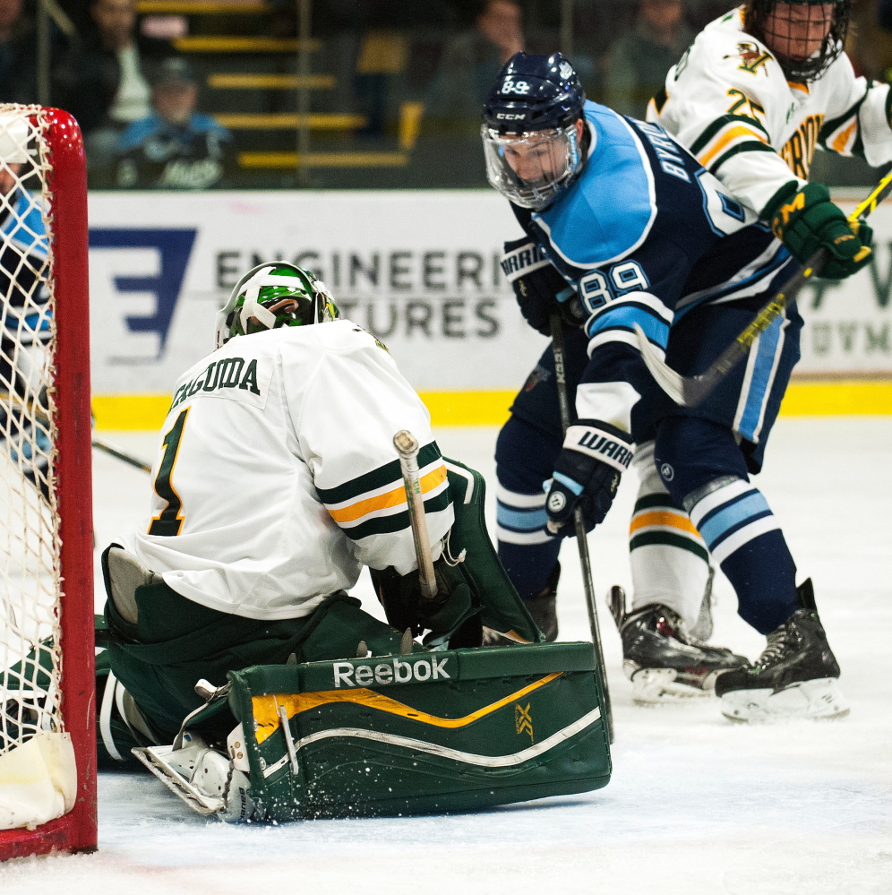 Maine’s Blaine Byron looks for a rebound in front of Vermont goalie Mike Santaguida during Game 3 of a Hockey East playoff series in March. He and Nolan Vesey return to the Black Bears this year as the top goal-scorers from last winter.
