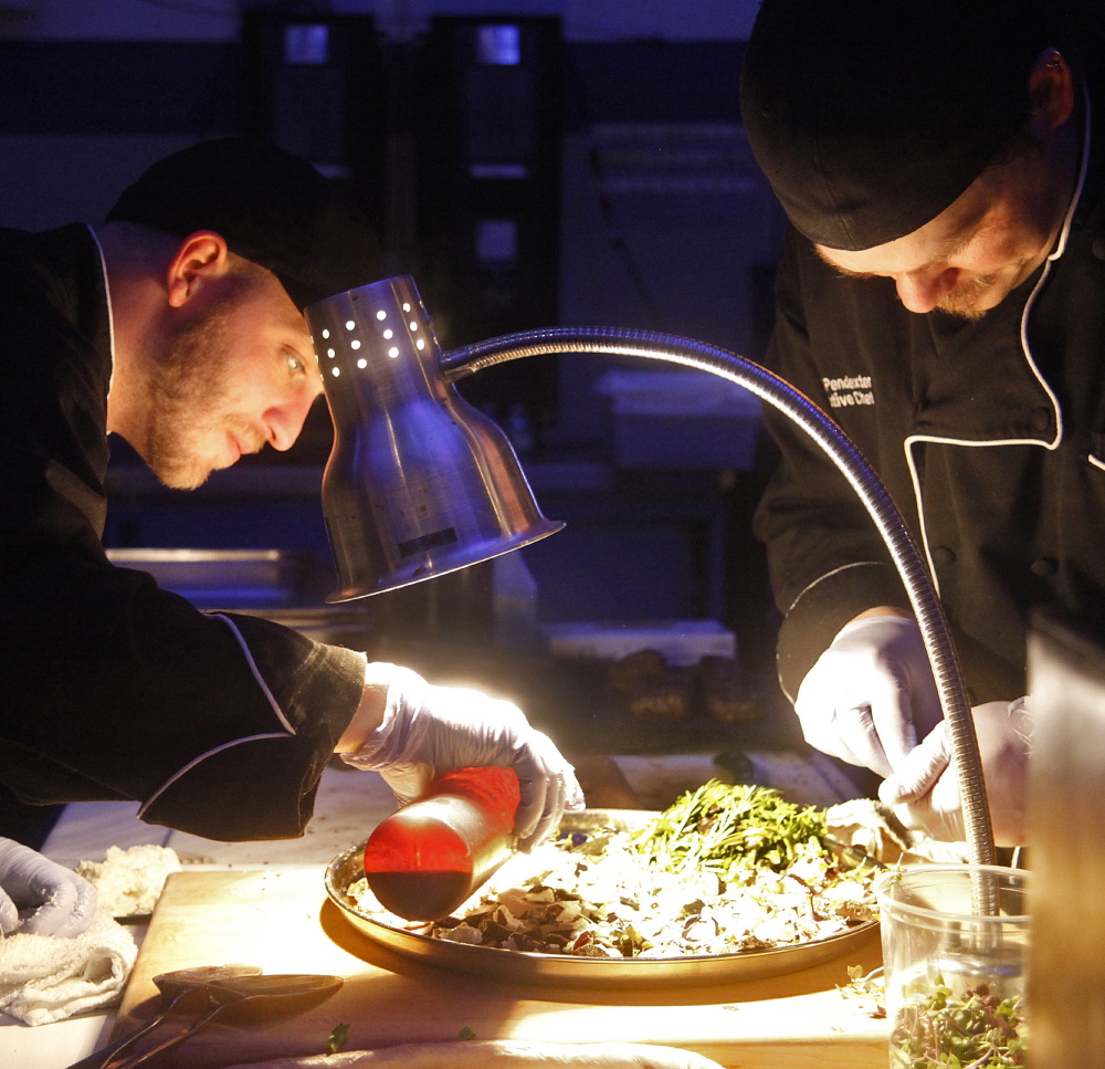 Joshua Alds and David Pendexter, sous and executive chefs, respectively, at the Brunswick Hotel & Tavern, prepare food at The Signature Event.