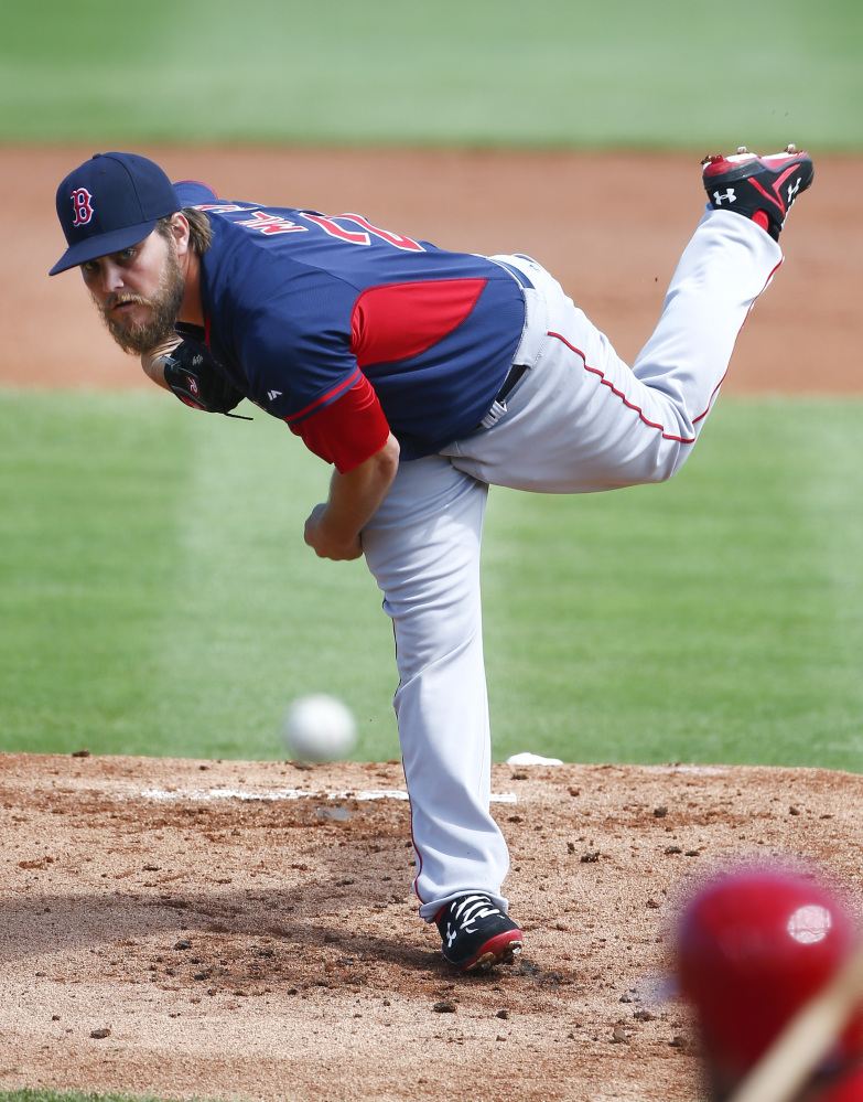 Boston Red Sox starting pitcher Wade Miley (20) works against the St. Louis Cardinals in the first inning of an exhibition spring training baseball game Monday, March 9, 2015, in Jupiter,  Fla. (AP Photo/John Bazemore)