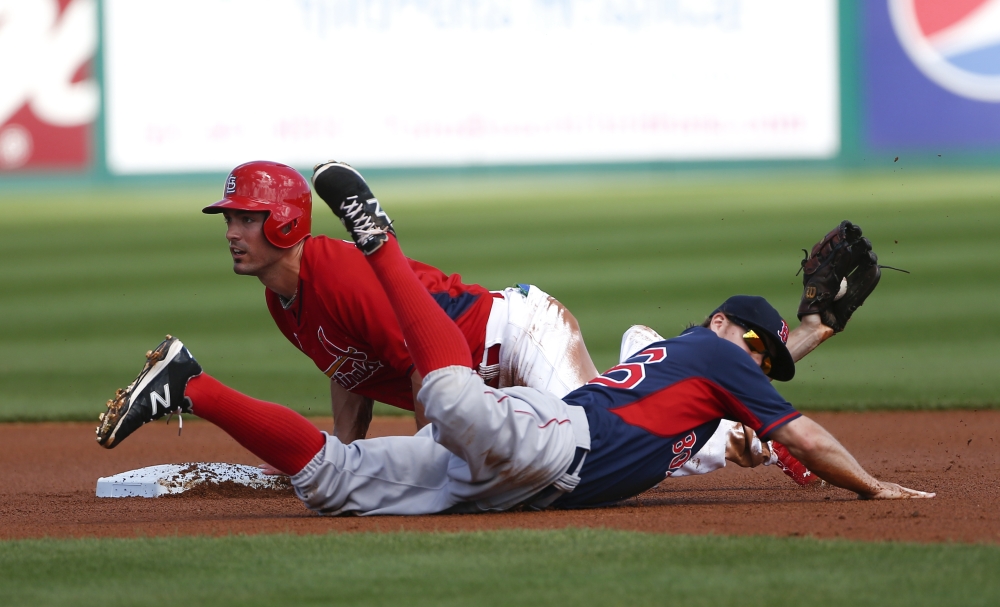 St. Louis Cardinals'  Randal Grichuk (15) is tagged out by Boston Red Sox second baseman Brock Holt (26) after being caught off base in the second inning of an exhibition spring training baseball game  Monday, March 9, 2015, in Jupiter,  Fla. (AP Photo/John Bazemore)