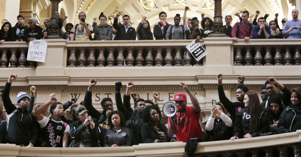 Demonstrators gather at the Wisconsin State Capitol rotunda in Madison on Monday to protest the killing of Tony Robinson. The 19-year-old was shot Friday by a police officer.